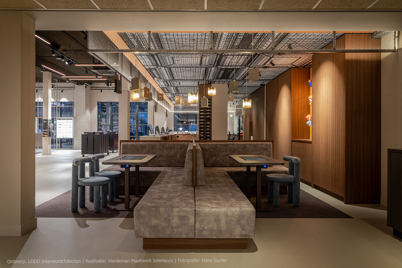 Optiekinterieur met wandmeubels in LS47 Poro Noce, een warmbruin kwartiers gezaagd walnootdecor met verticale nerf.